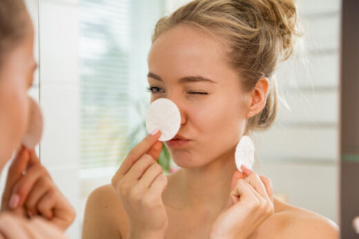 Young Beautiful Woman Cleaning Her Face Skin With Cotton Pad