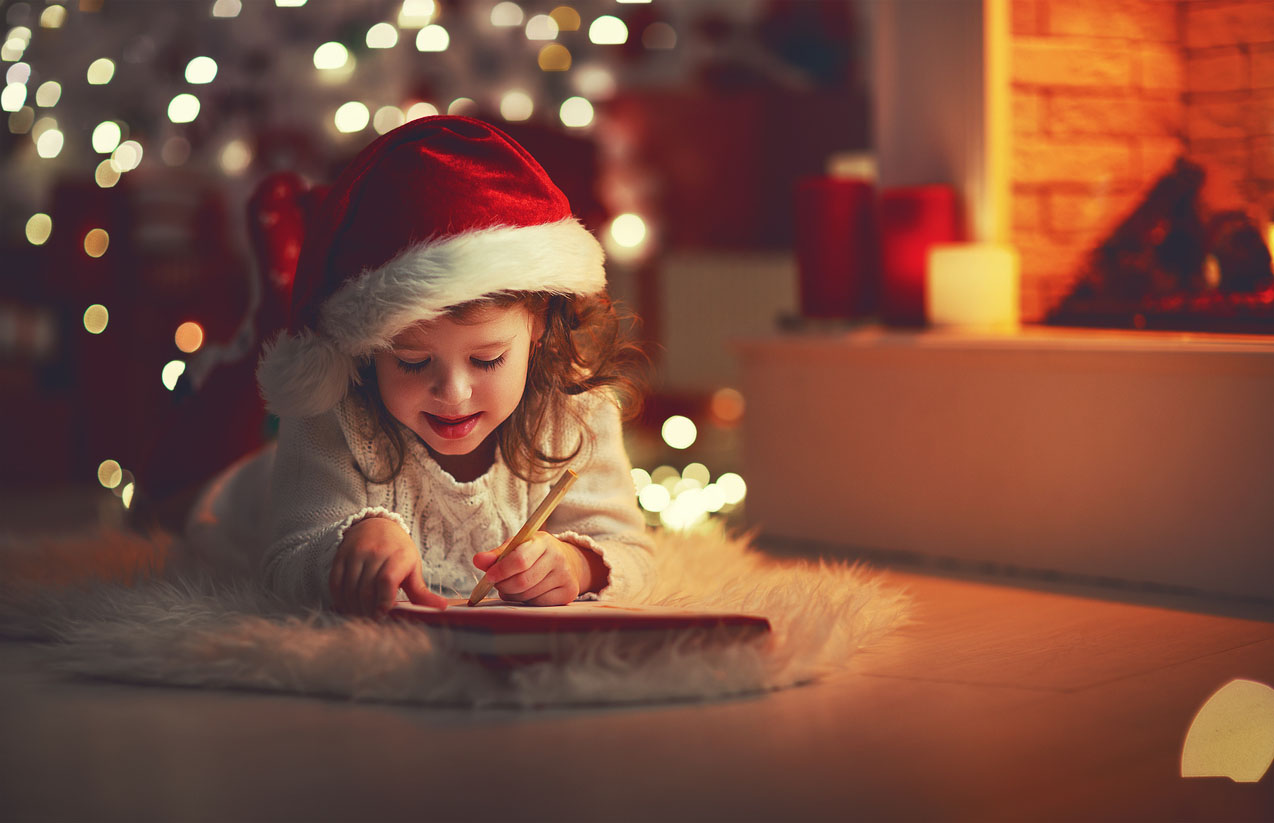 Fille enfant écrivant maison santa lettre près de sapin de Noël